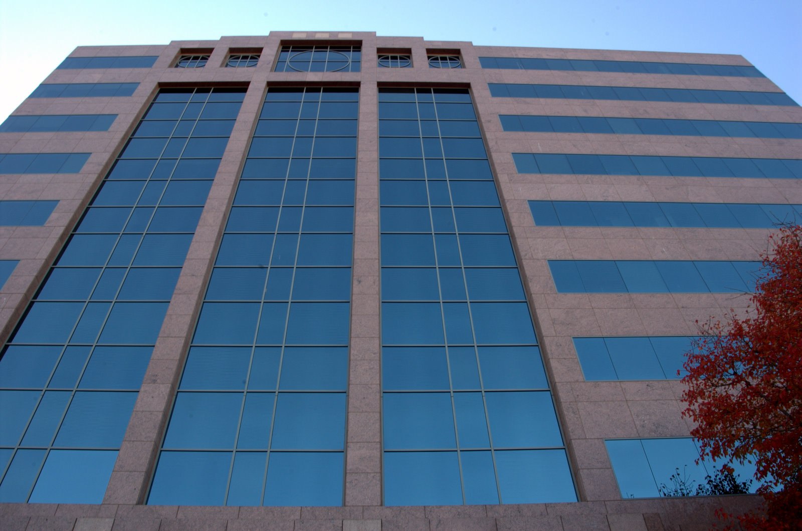 Striped office building under a clear sky